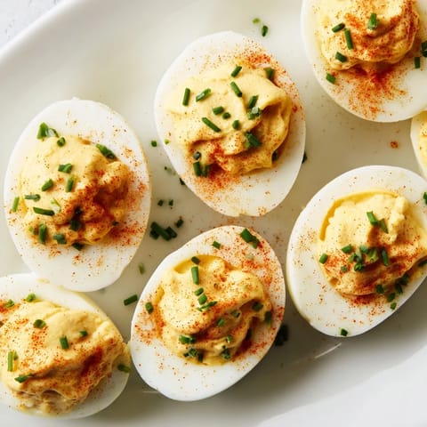 Classic American deviled eggs served as a gluten-free vegetarian snack, creamy yolk filling in halved egg whites.