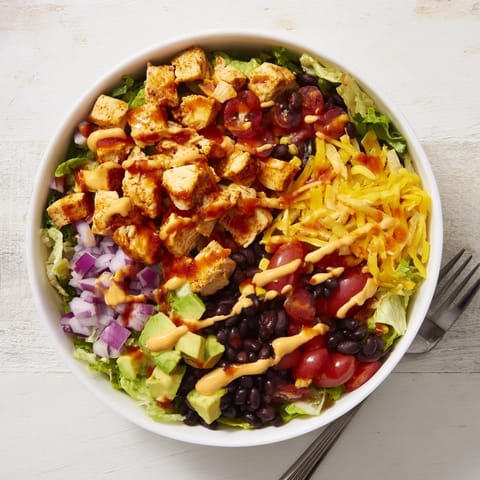 Top-down view of Chicken Taco Chopped Salad, featuring colorful veggies and crushed tortilla chips for a crunchy, satisfying Tex-Mex meal.