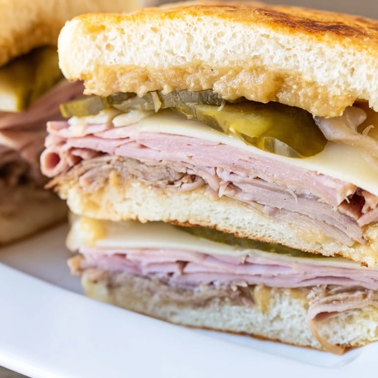 Buttery toasted Cuban sandwich fresh from the panini press, with melted Swiss and tangy mustard gleaming.