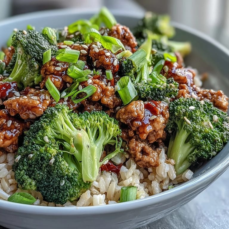A vibrant dinner bowl featuring Sweet and Spicy Turkey Broccoli Bowls garnished with green onions.