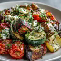 Roasted Mediterranean Greek Vegetables, caramelized and served warm with crumbled feta and fresh parsley.