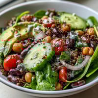 Freshly diced red bell pepper and cucumber add crunch to the vibrant Three-Bean Power Bowl. 